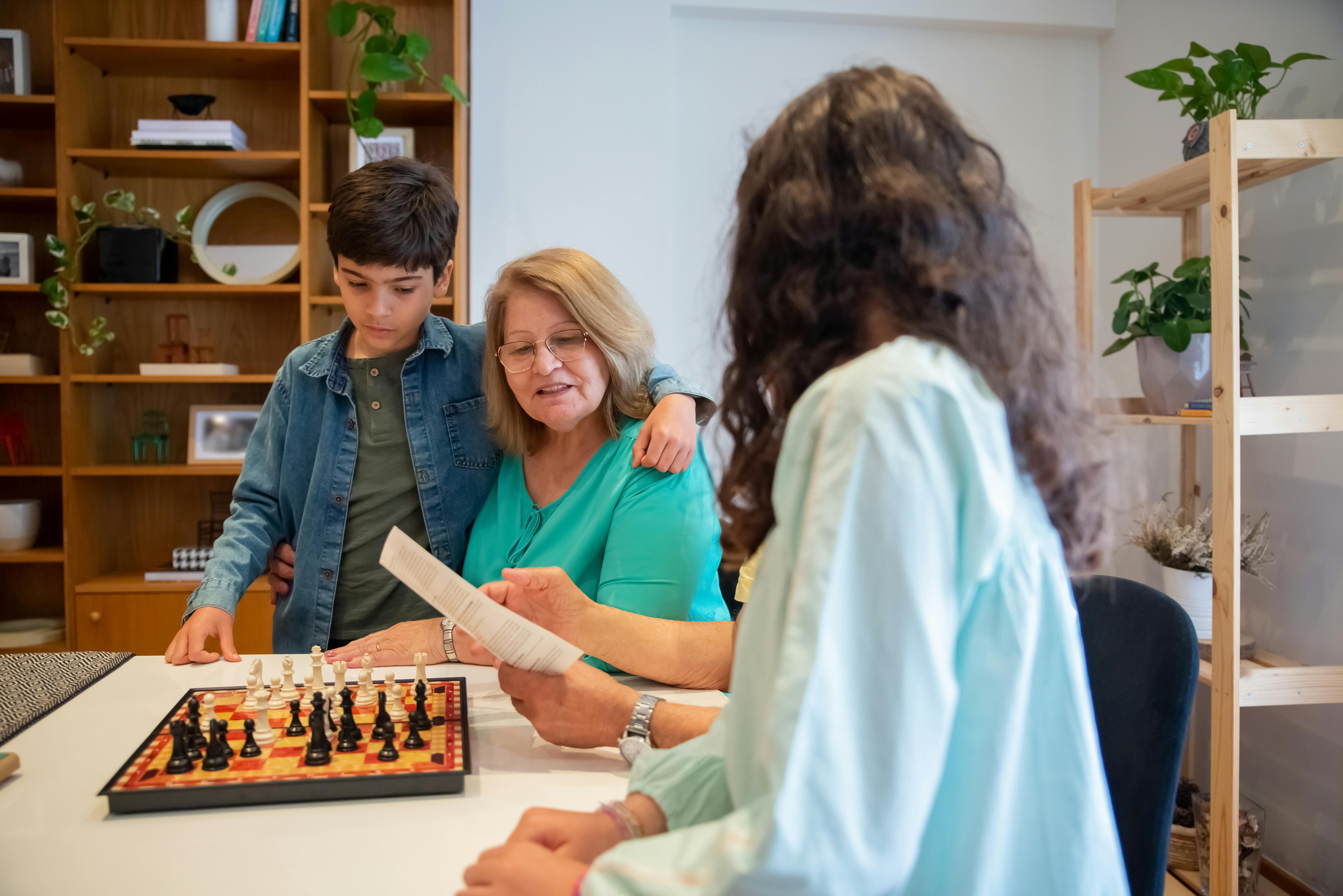 Family bond strengthened through chess at home, featuring multiple generations.
